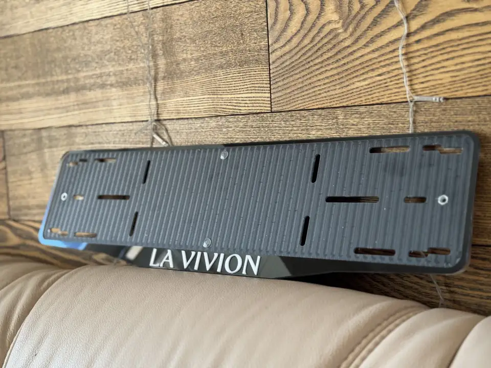 LA VIVION · чёрный глянец, белые буквы Чёрная глянцевая номерная рамка LA VIVION с белыми объёмными буквами